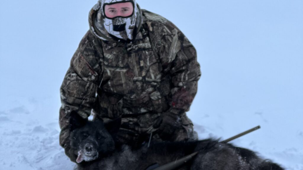 Hunter with wolf after 8 hour winter sit